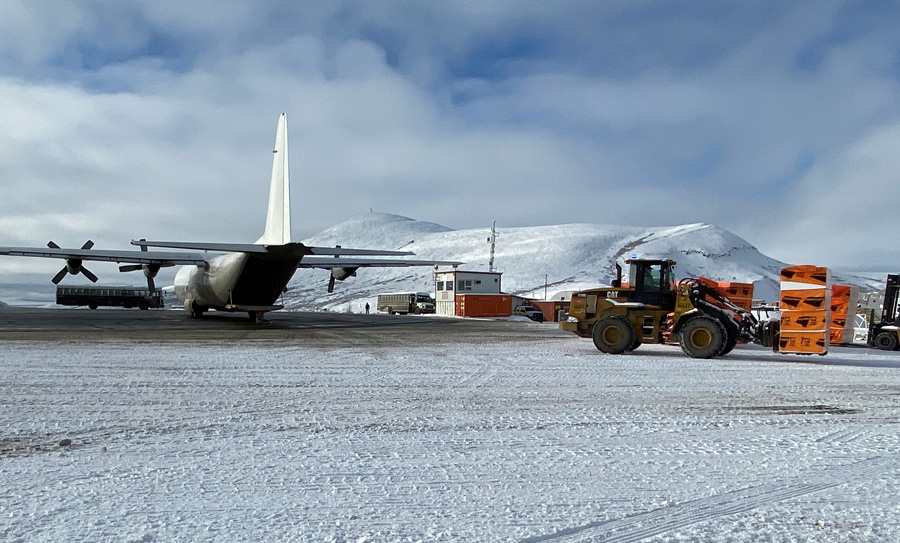 plane and front loader in the snow