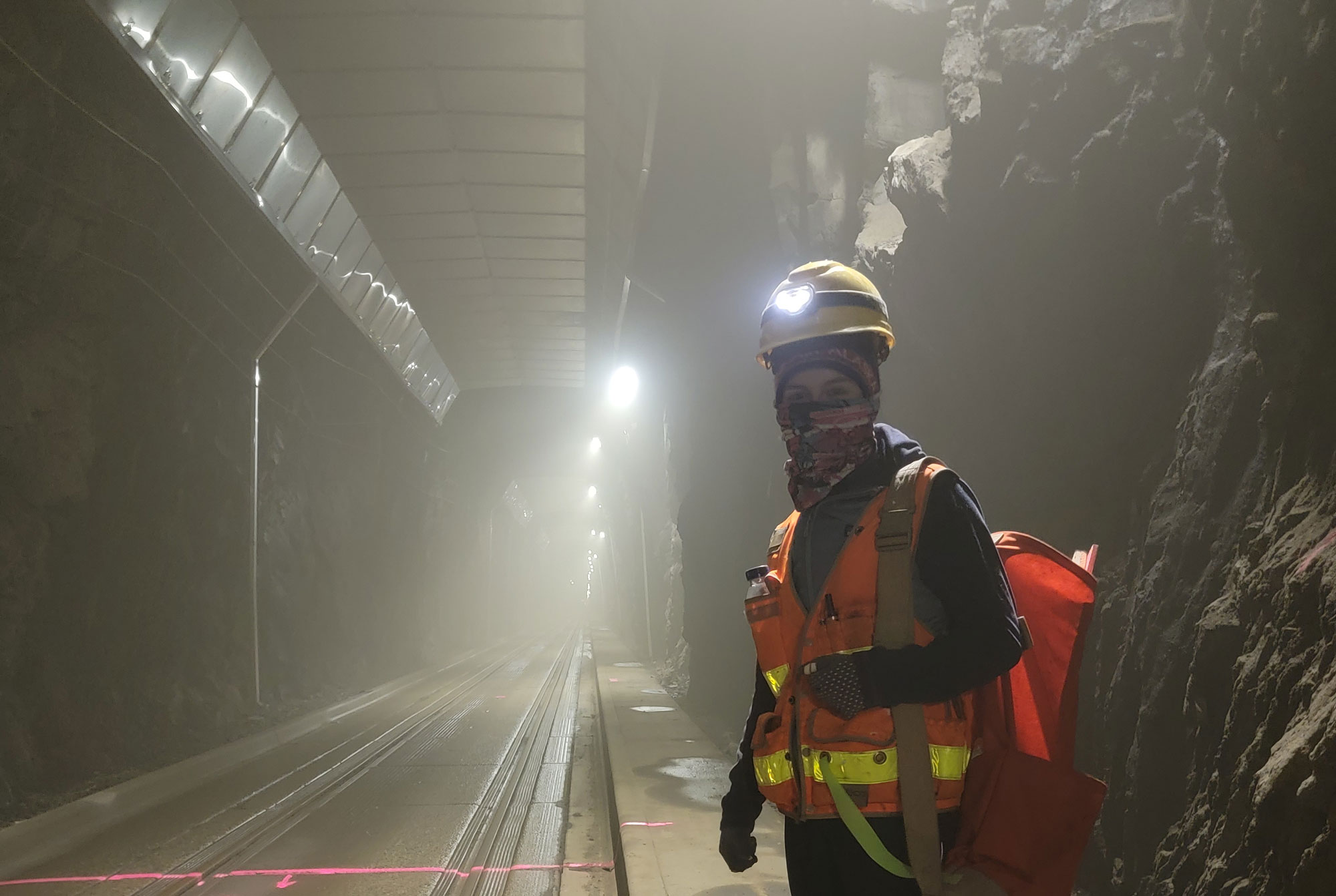 Faren Crow, an ACS crewmember, locates survey control points in the Whittier Tunnel