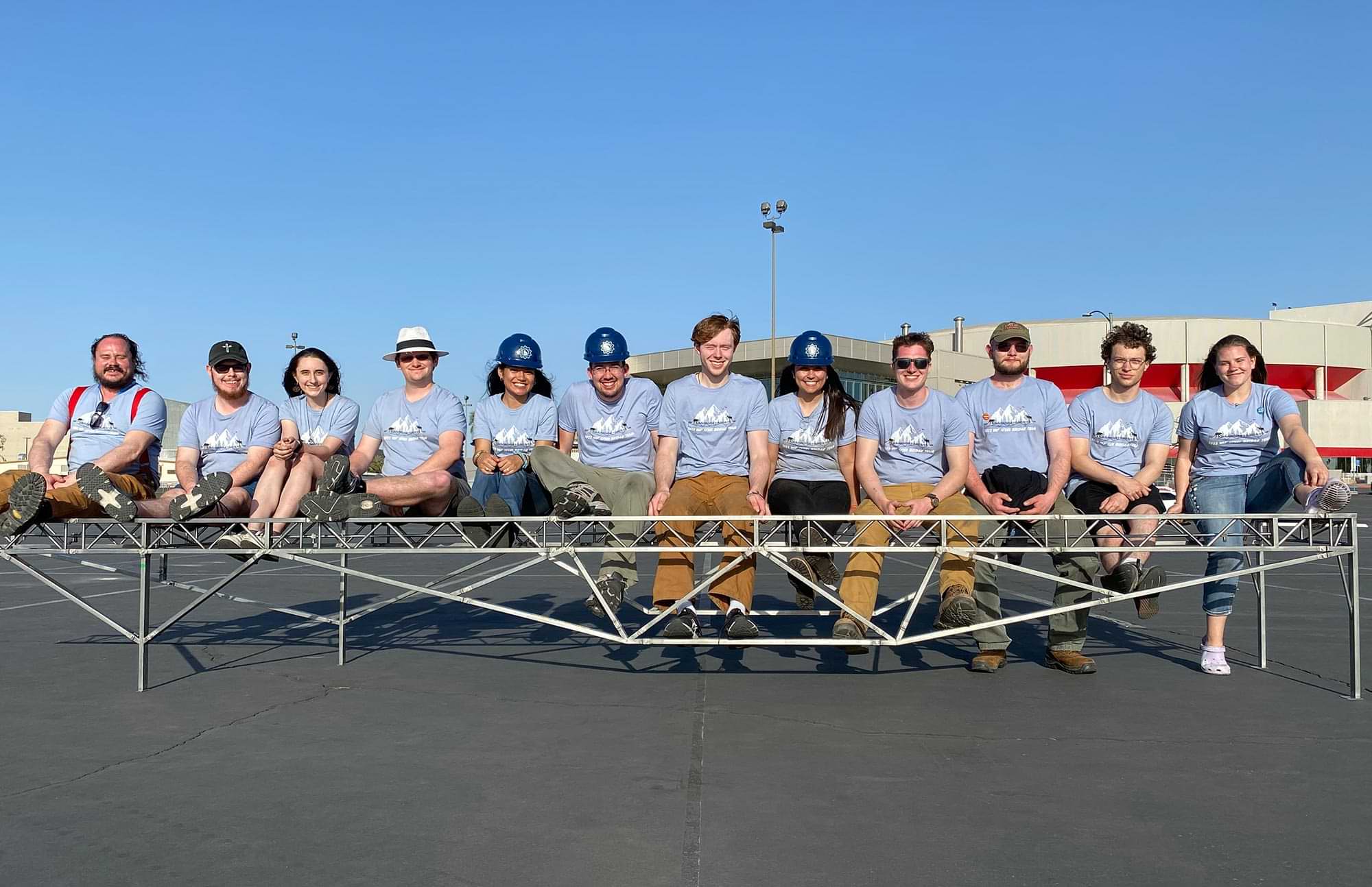 the entire UAF Steel Bridge team sits on the bridge after competing at the regional competition at University of Nevada Las Vegas