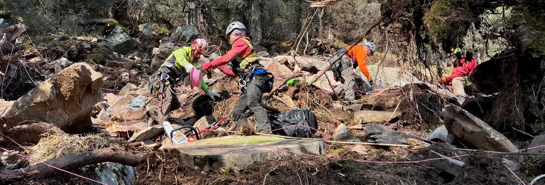 a clean up crew works on a landslide area