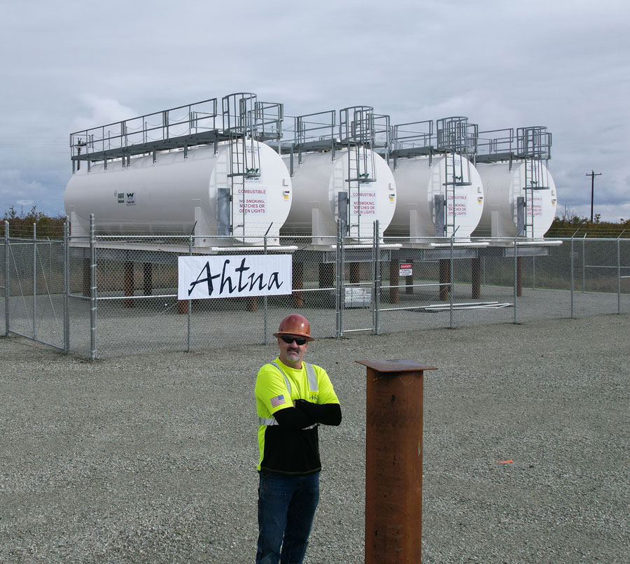construction worker standing in front of tanks from Ahtna