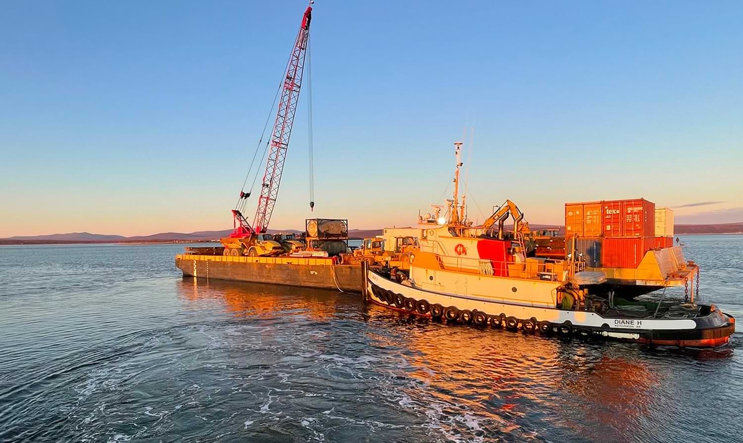 a barge filled with Tumet Industries, LLC loaded equipment and supplies on water