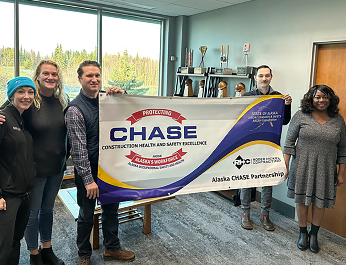 people holding CHASE partnership banner