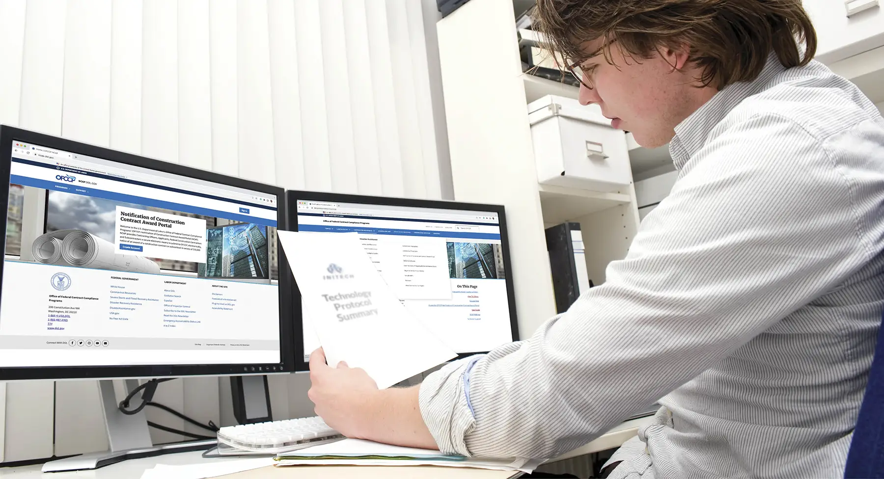 Man looking at computer screen with OFCCP portal website