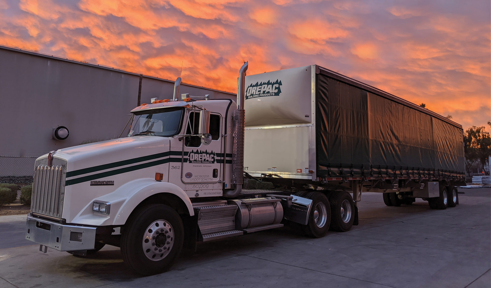 Semi-truck with sunset behind