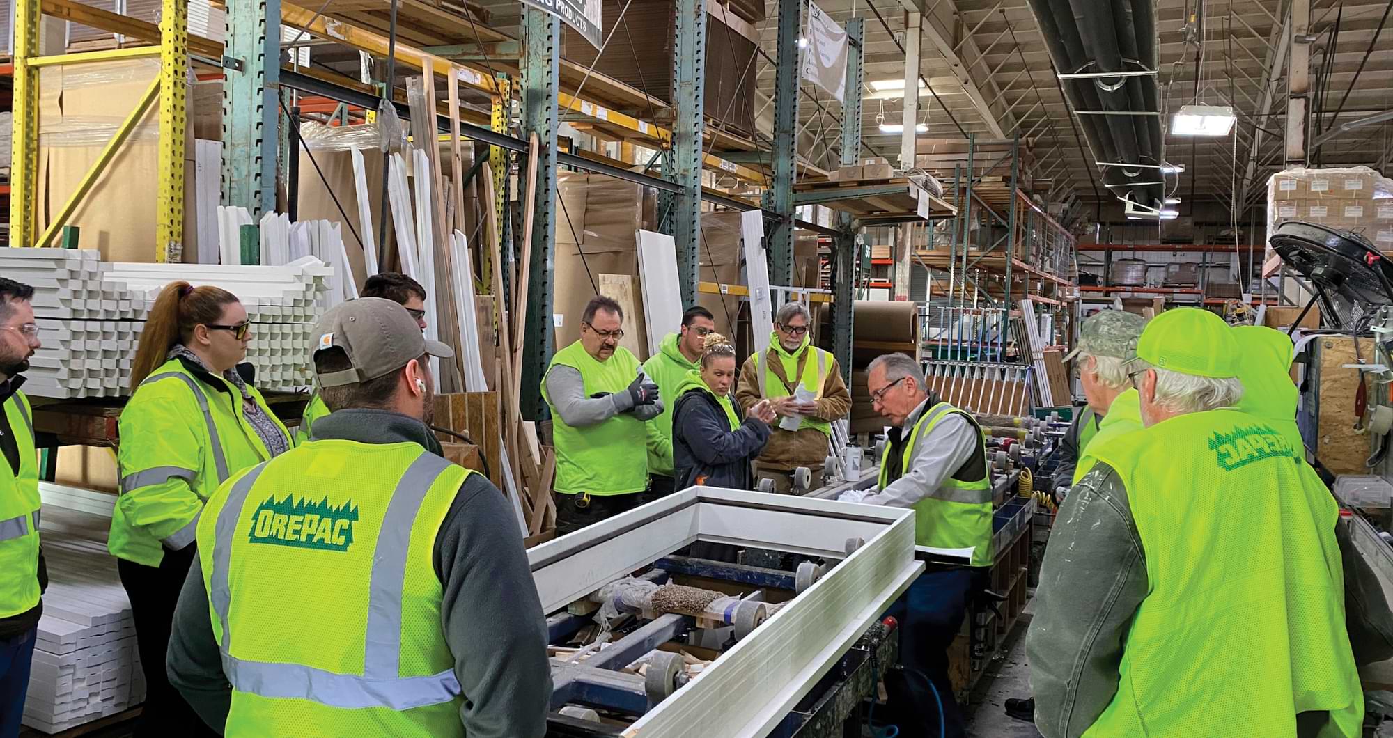 workers wearing bright green vest in warehouse