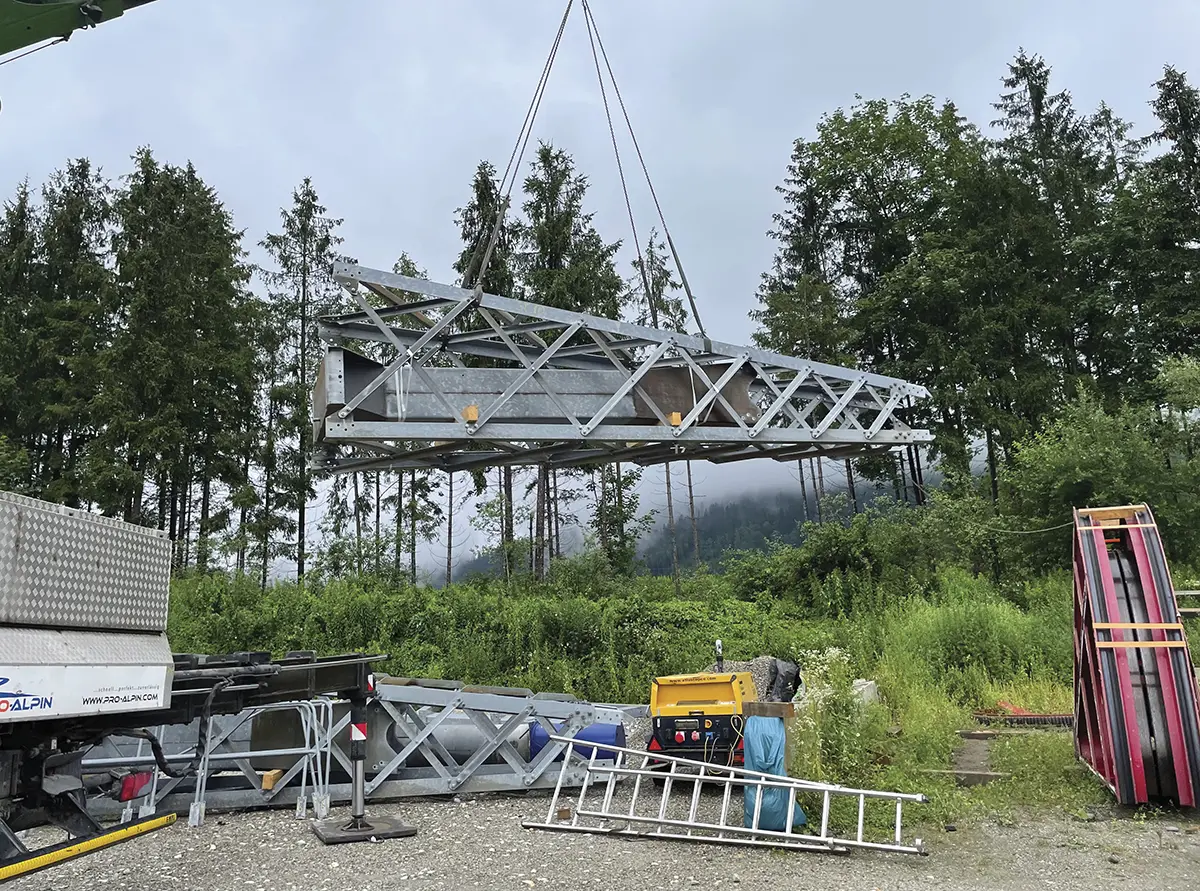Boom crane lifting large steel girder