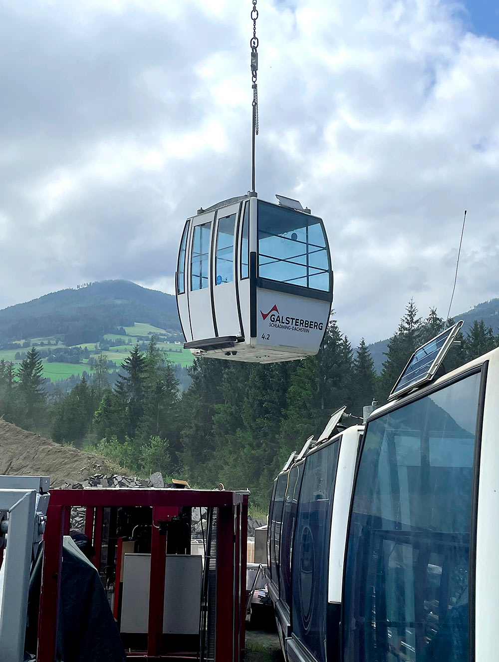 Gondola cabin being airlifted by helicopter