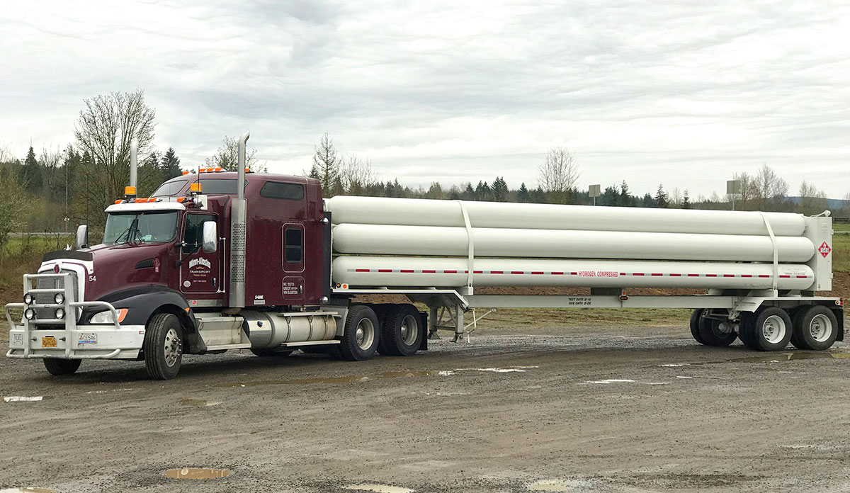 Maroon Kenworth with bullbar hauling hydrogen tanks