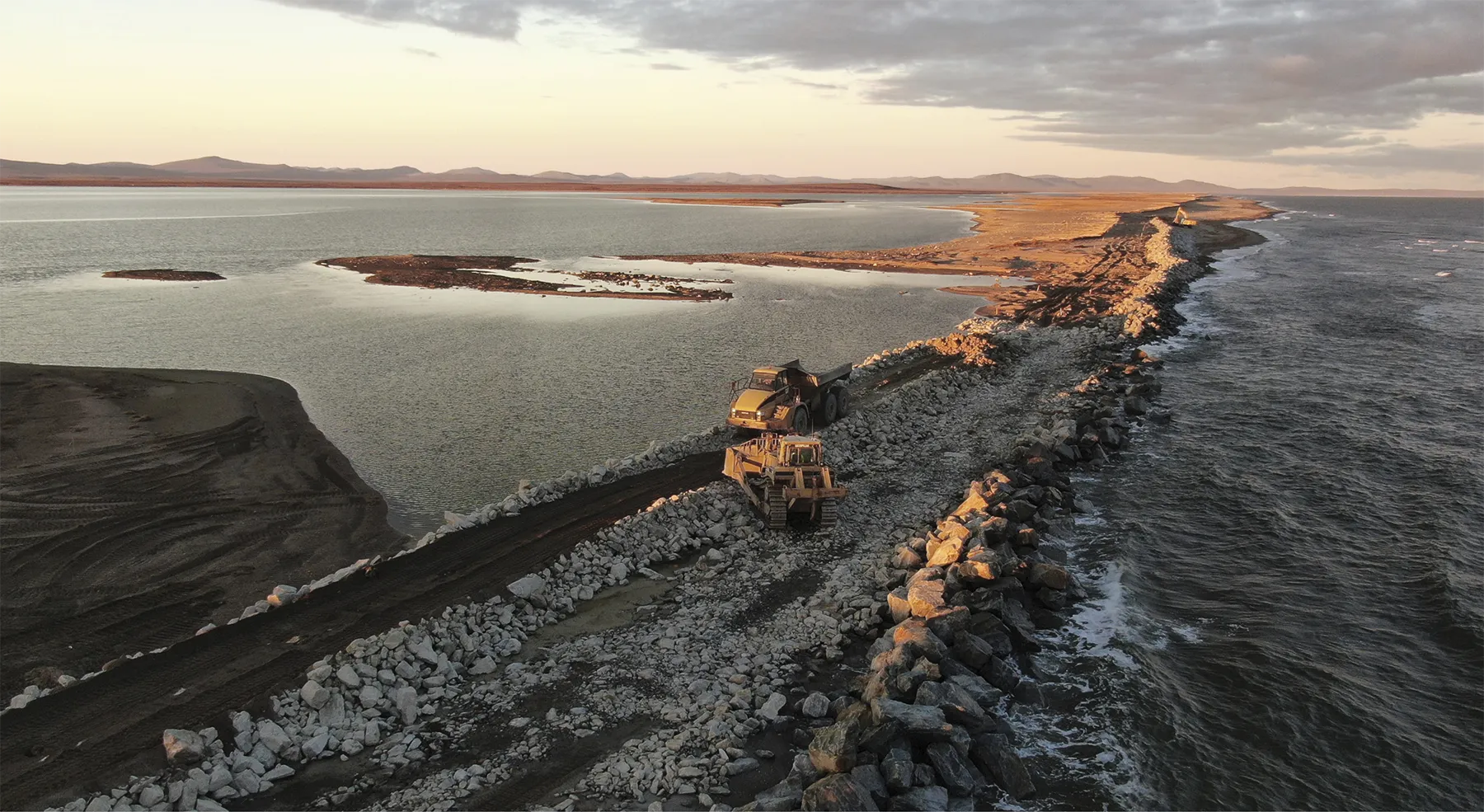 Knik Construction worked with the Alaska Department of Transportation and Public Facilities to repair protective water berms destroyed by Typhoon Merbok. These berms provide flood defense and prevent coastal erosion.