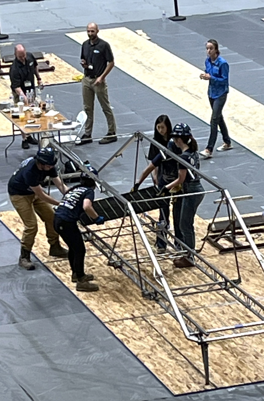 workers assembling on metal frame
