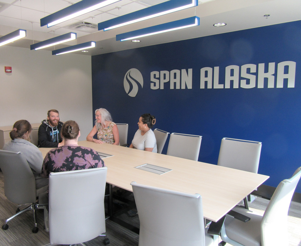 Group of people in Span Alaska's conference room