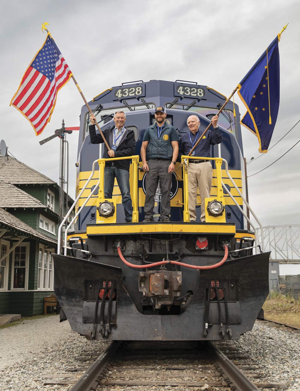 ARRC members proudly wave flags on the centennial locomotive