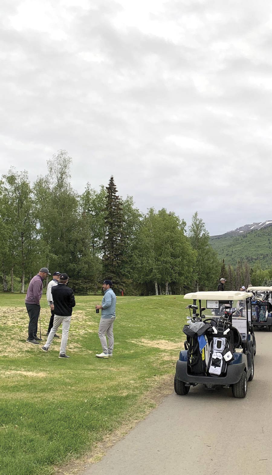 group of golfers talking on the course
