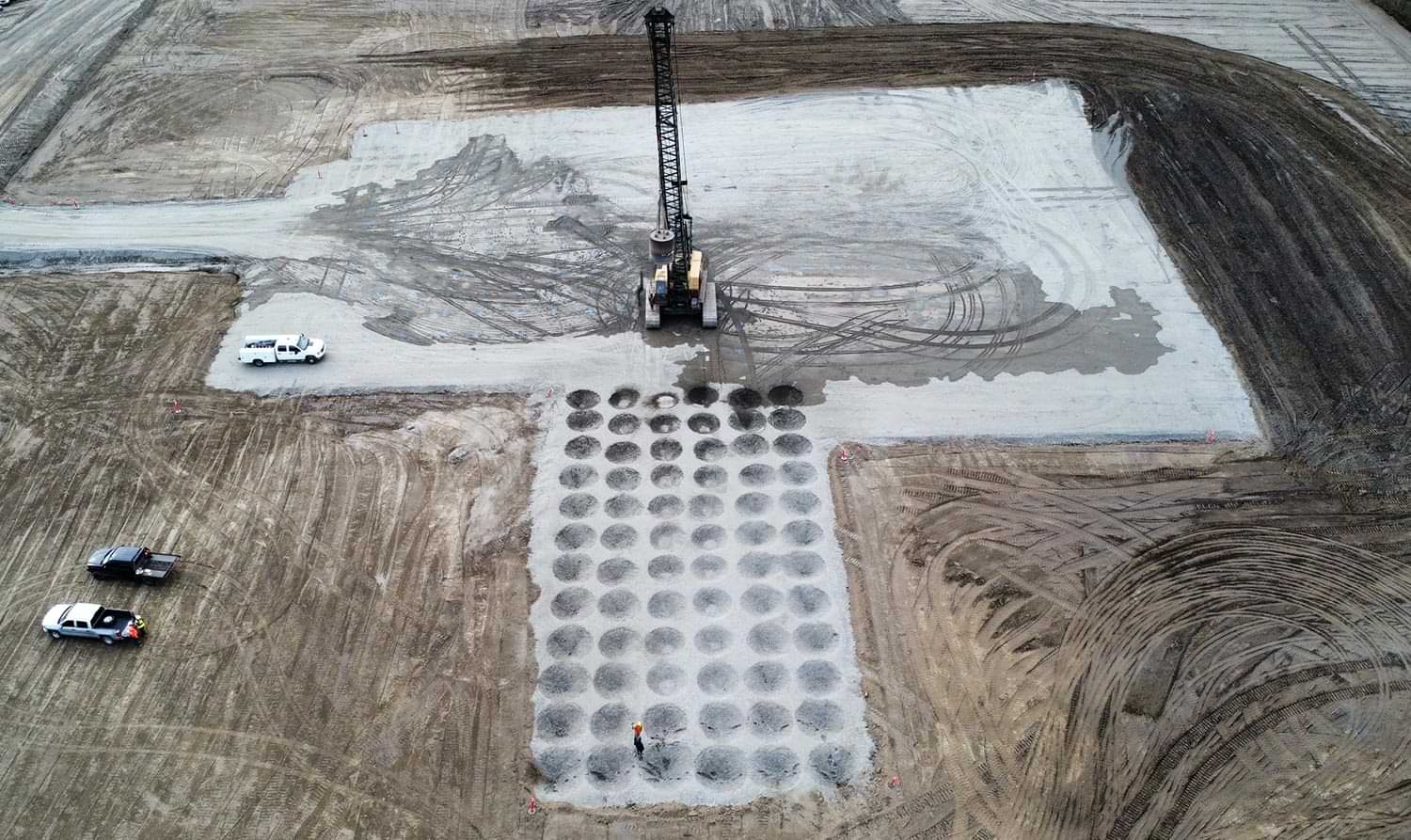 aerial view of Precision Cranes’ workers executing deep dynamic compaction on predetermined construction land