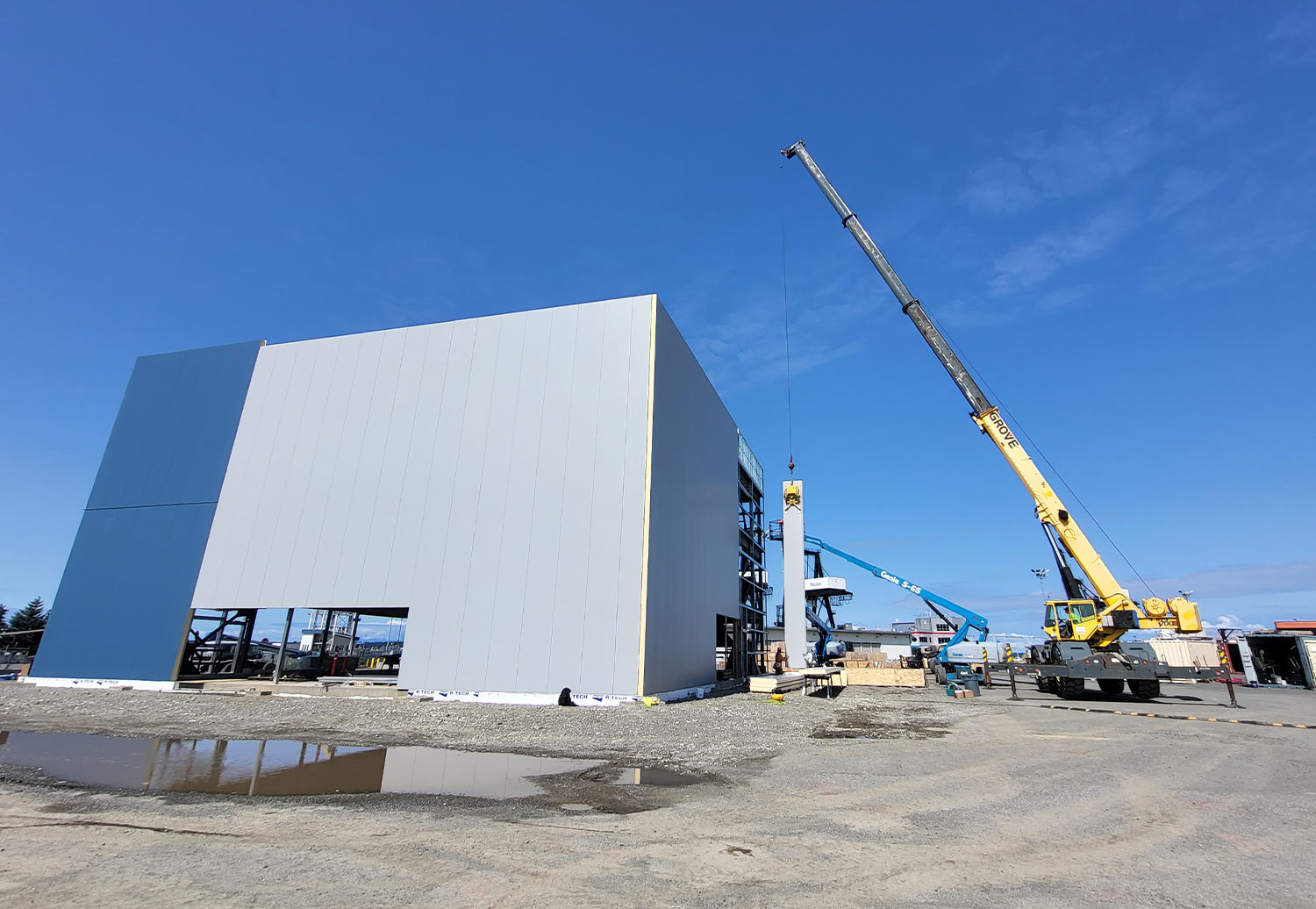 a crane is used to place the outer shell on the new Port of Alaska administrative building