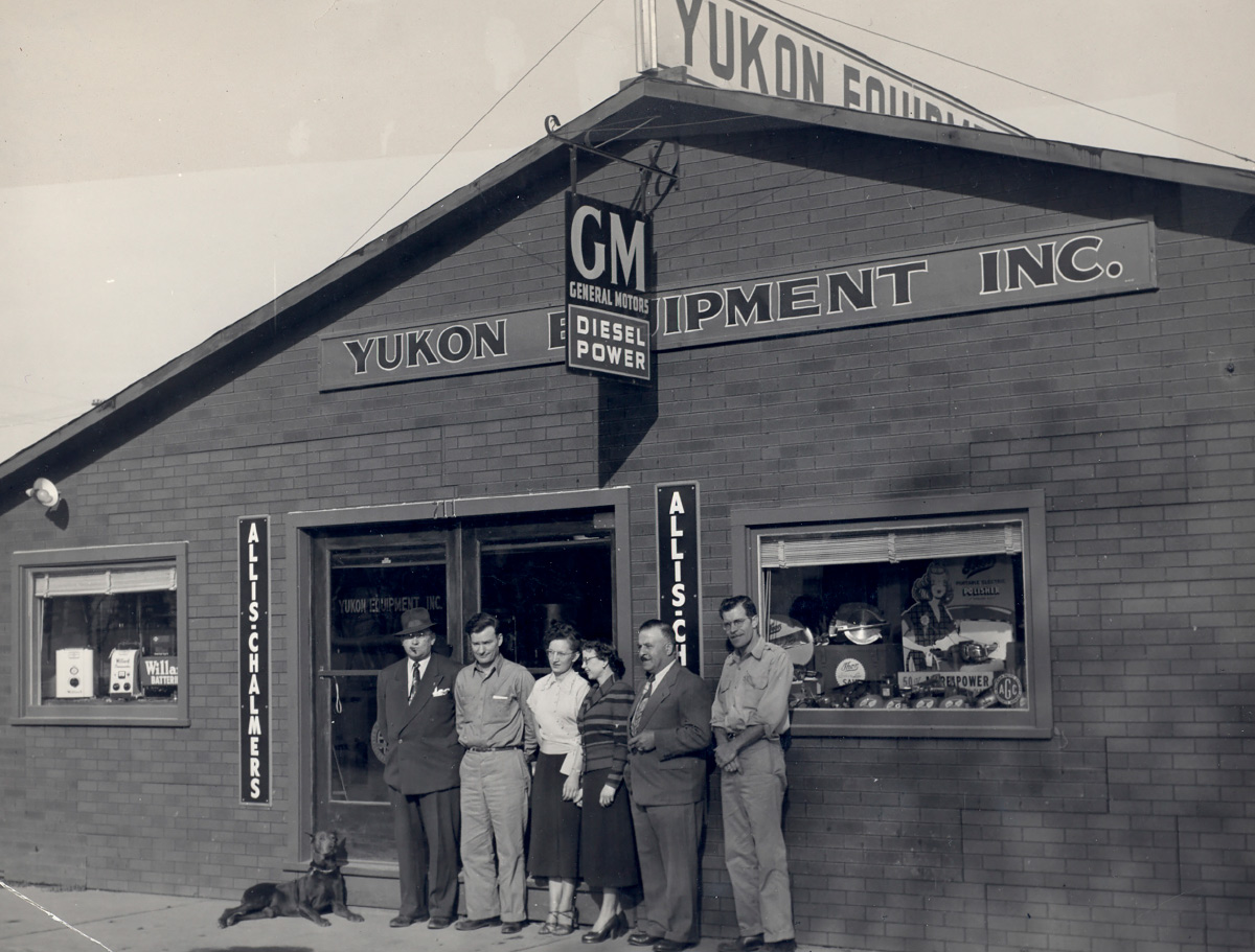 earliest AGC of Alaska members in front of construction store building