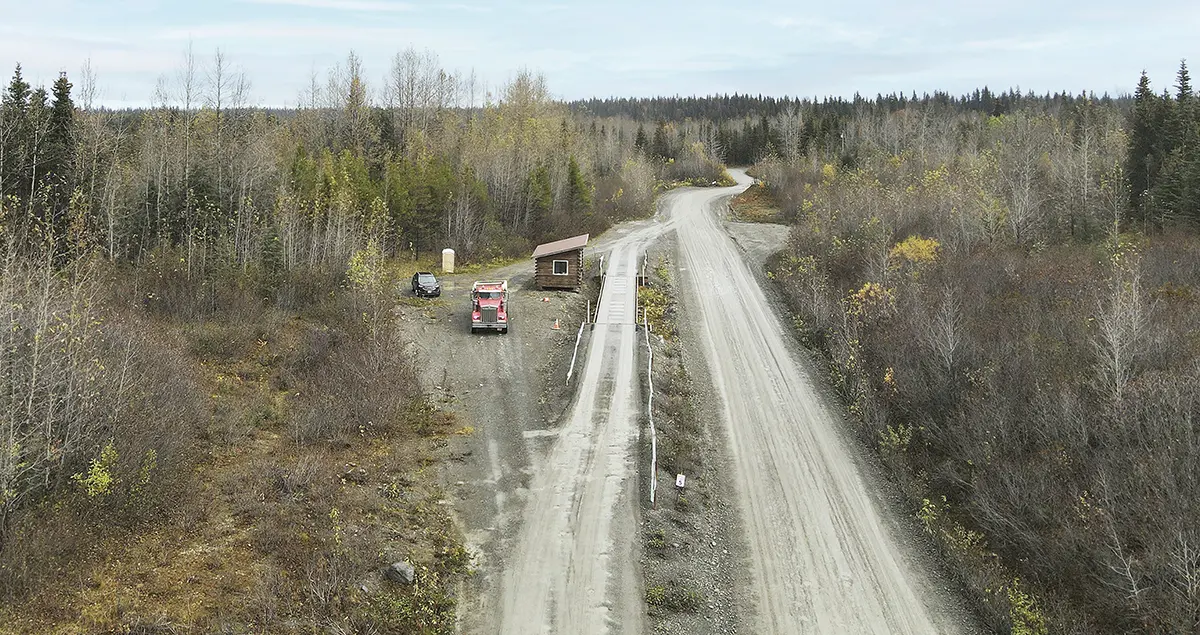 Truck scales at Cook Inlet Region, Inc. on dirt road cutting through woods