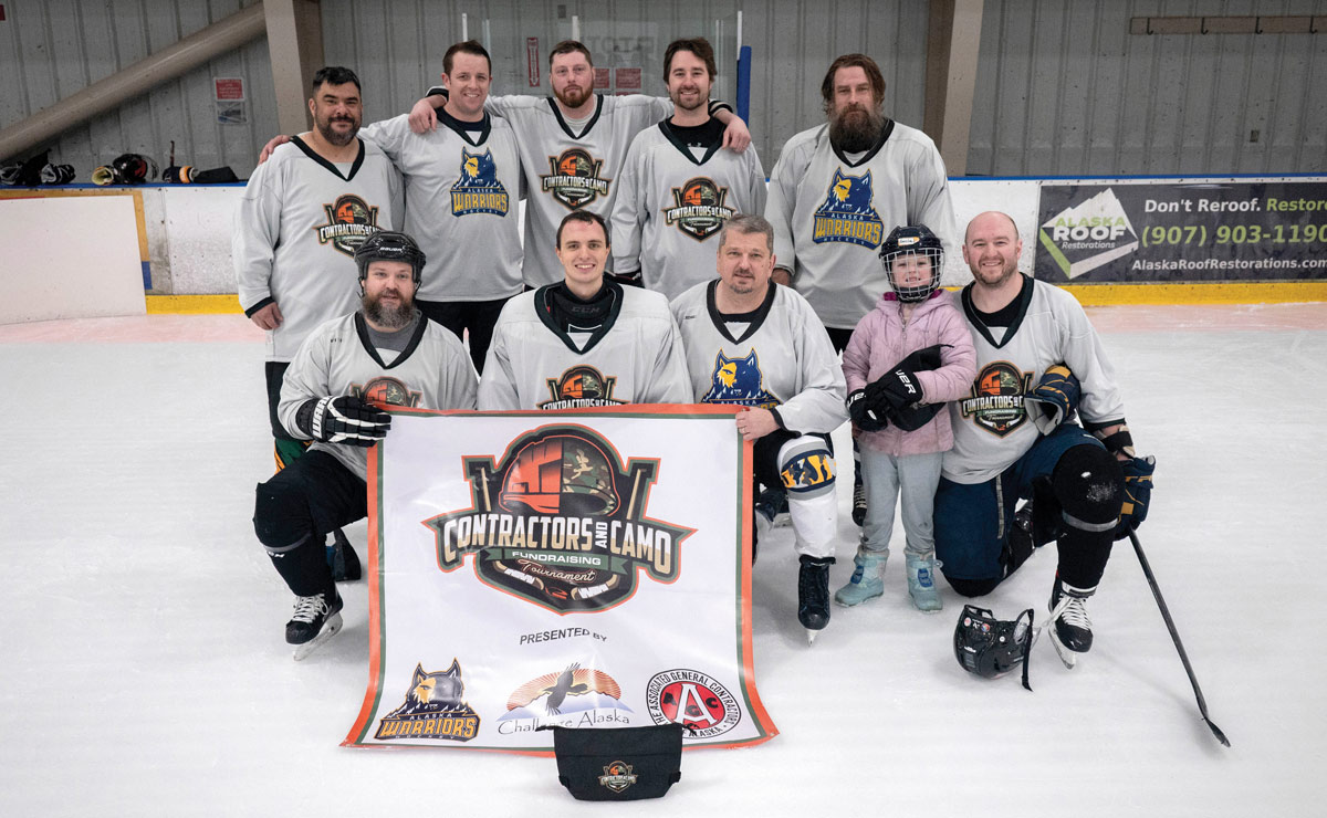 team from the Contractors & Camo Hockey Tournament with a banner