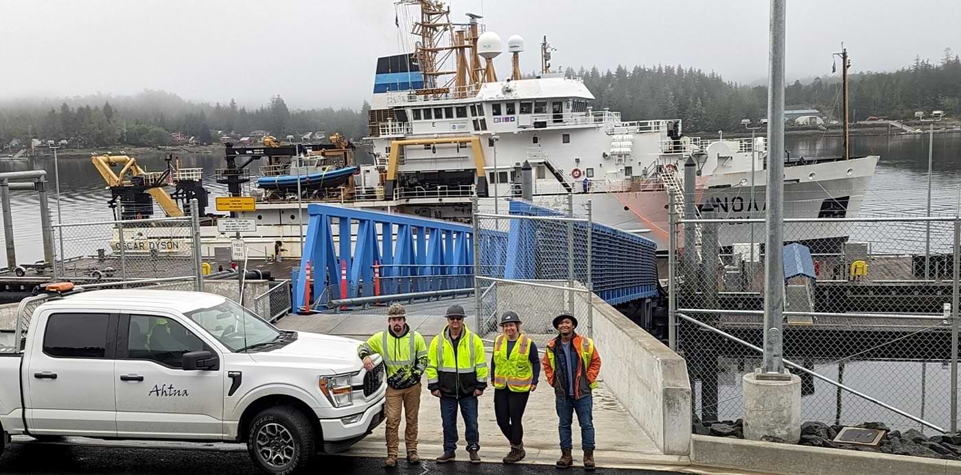 four construction workers stand in front of a Ahtna labeled truck parked in front of the Fairweather Homeport recapitalization project in Ketchikan