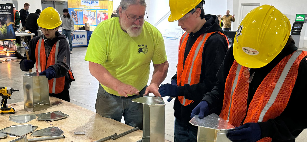 three students building metal tool boxes during Alaska Construction Career Day