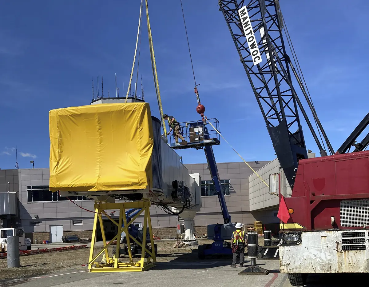 crane demolishing a passenger boarding bridge