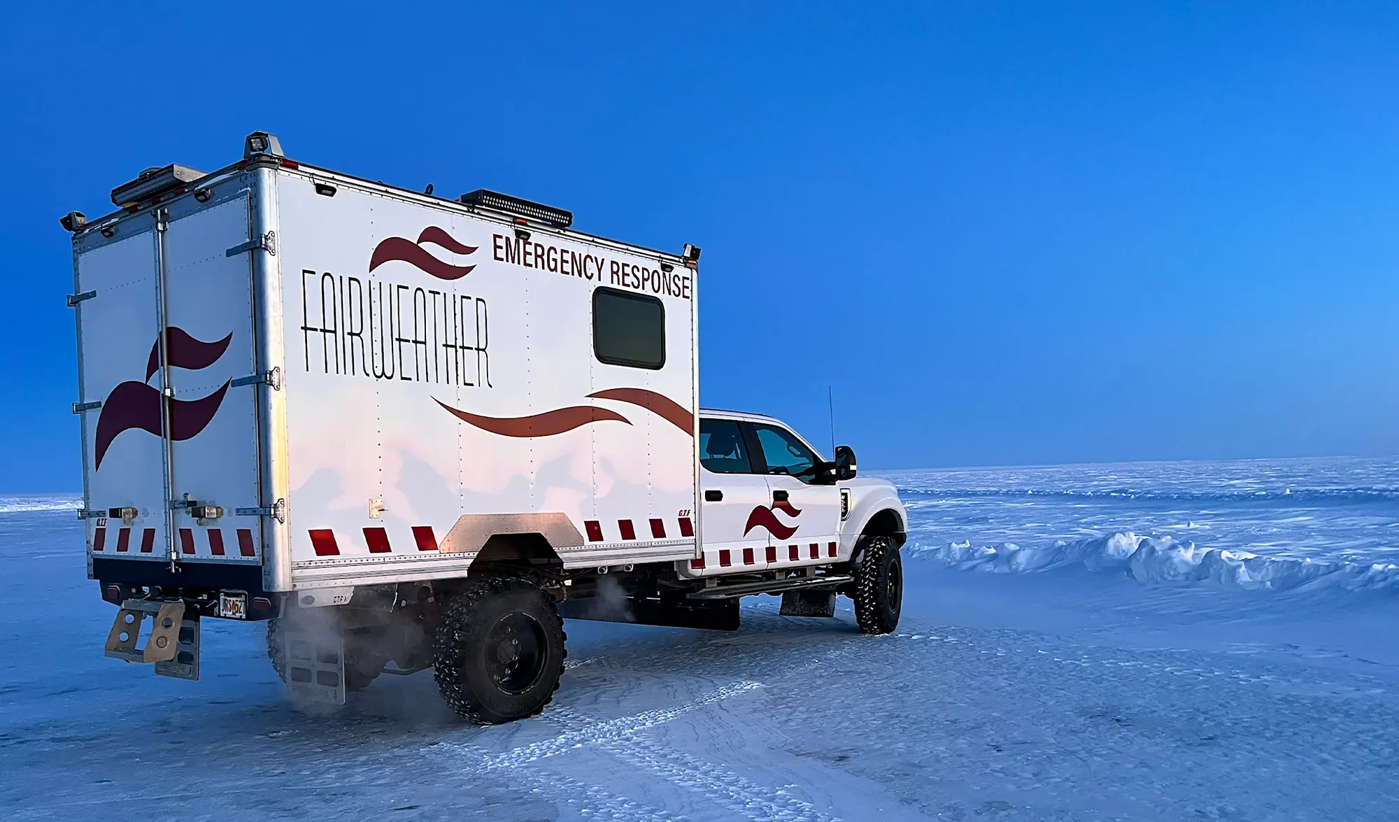 quarter rear view of Fairweather’s custom built Emergency Response Vehicle parked on an icy plain on the North Slope