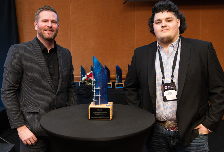 Matt Thon and Emiliano Rodriguez standing next to award