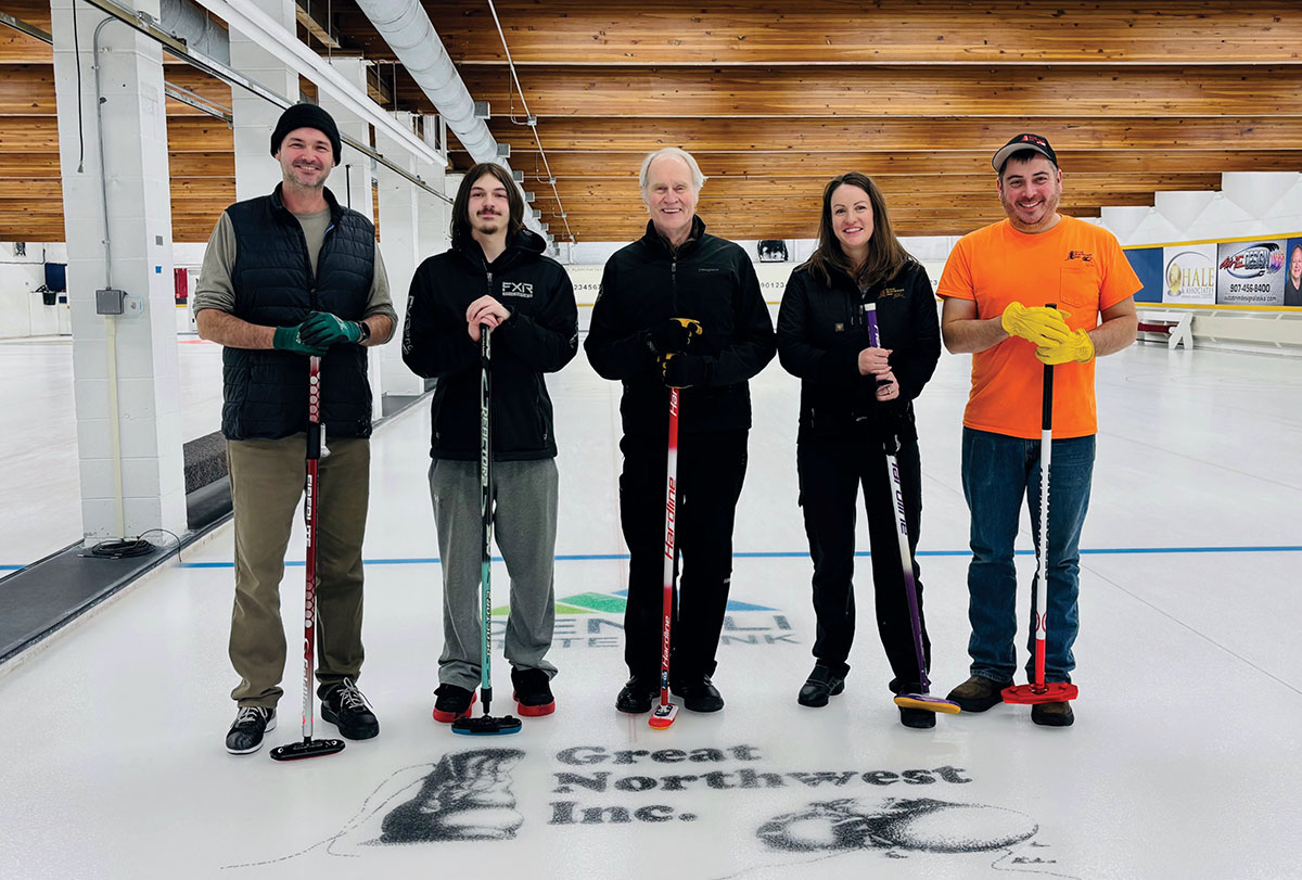 4 male and 1 female curling team members holding sweepers on the ice