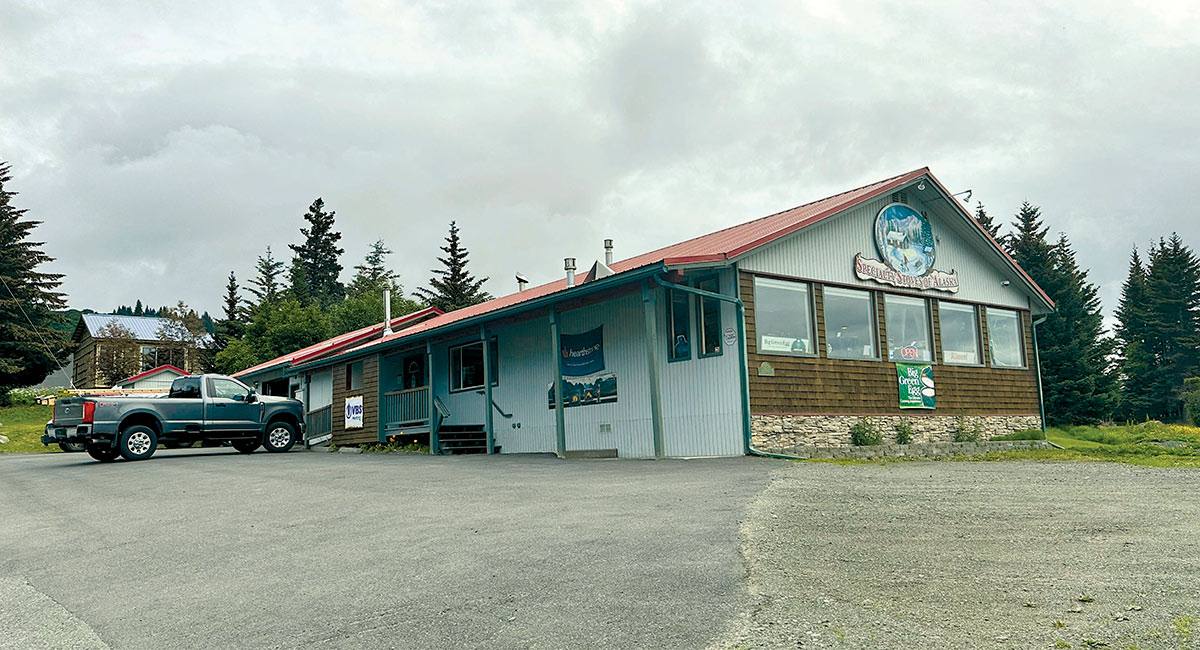 Exterior view of a commercial building under a cloudy sky.